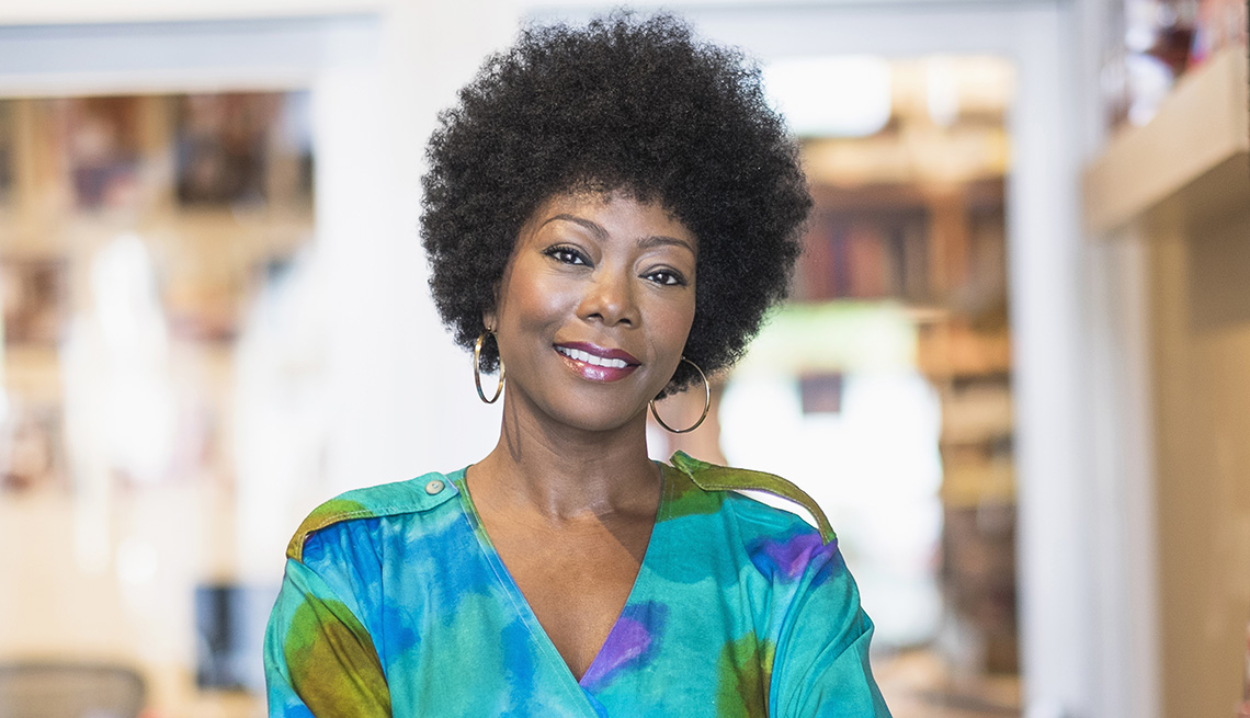 A woman with natural hair smiling