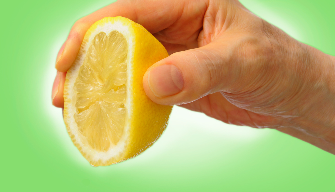hand squeezing a lemon
