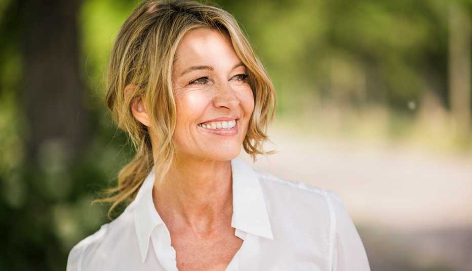 A woman smiling outside on a sunny day A woman smiling outside on a sunny day