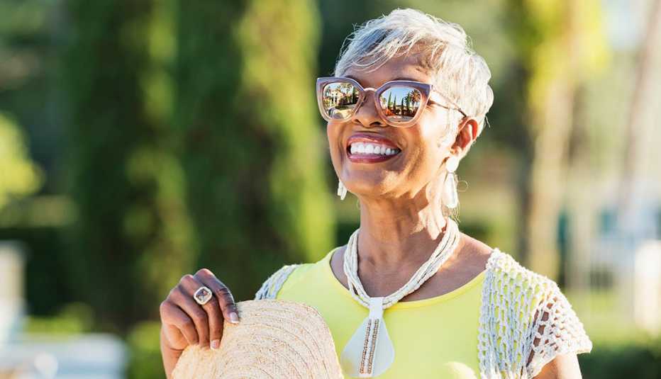 A woman wearing sunglasses on a sunny day A woman wearing sunglasses on a sunny day