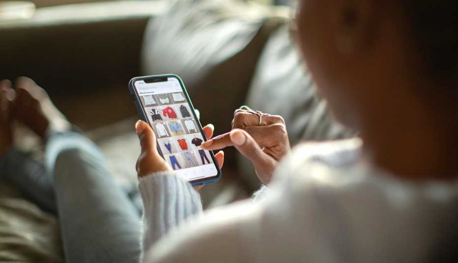 a woman shopping for clothing on her phone
