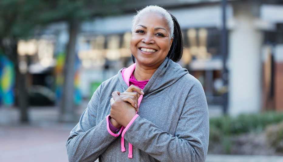 A woman wearing a gray hooded sweatshirt