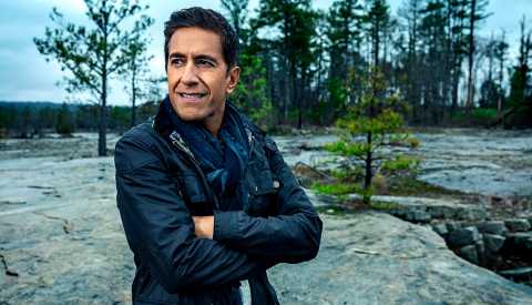 doctor sanjay gupta standing outdoors with arms crossed looking thoughtful