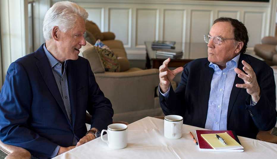 Bill Clinton and James Patterson sitting at a table.