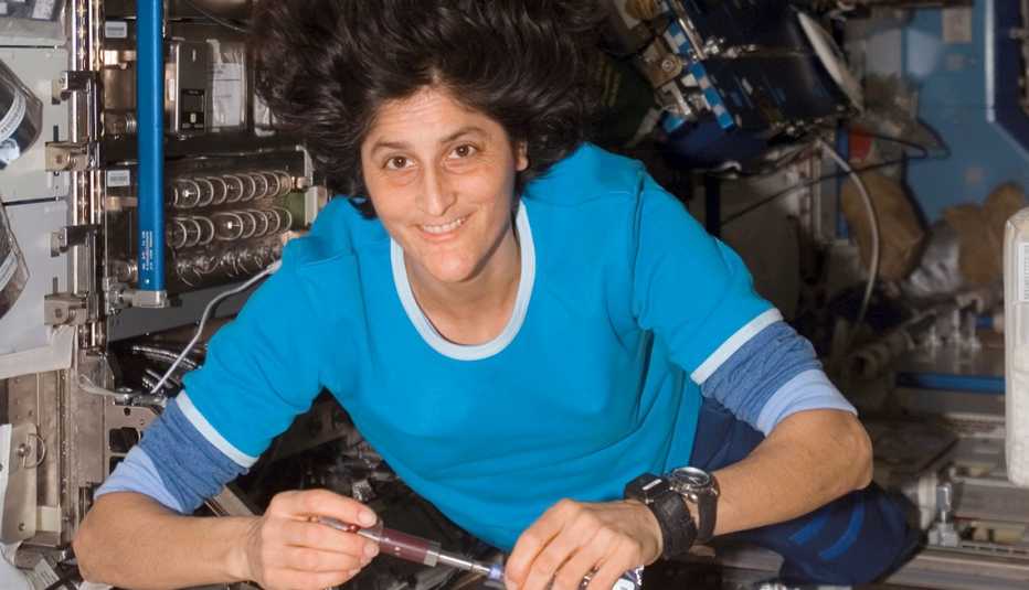 inside a spacecraft in zero gravity an astronaut works on instruments