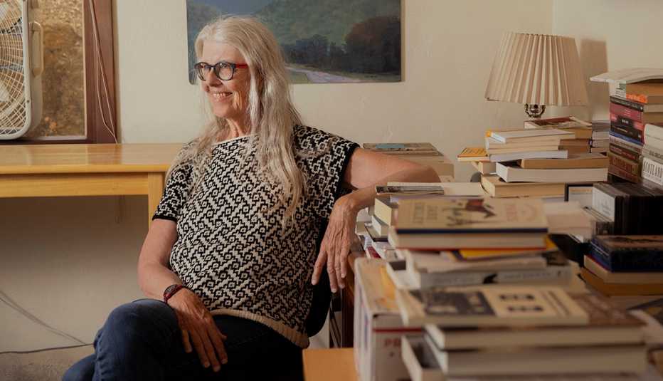 Author Jane Smiley at home in Carmel Valley, Calif., on Sunday, August 20, 2023. Smiley has three new books being released in the span of 18 months. author jane smiley at home sitting near a table filled with books