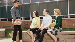 Teens in front of high school in 1963. (ClassicStock/Alamy)