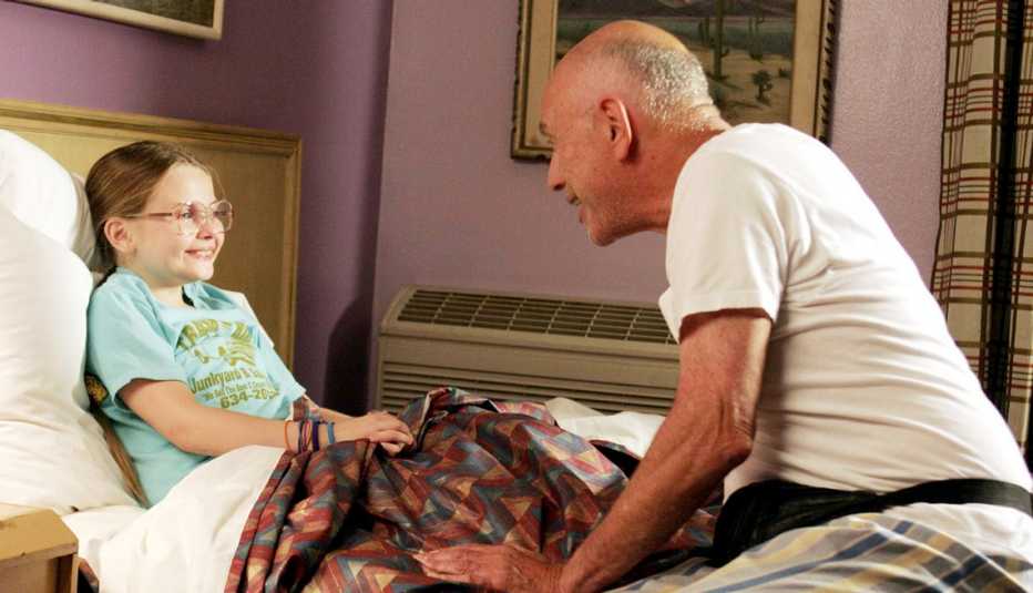 Abigail Breslin and Alan Arkin in a scene together in the film, "Little Miss Sunshine." alan arkin talking to abigail breslin while she is in her bed in a scene from the film little miss sunshine