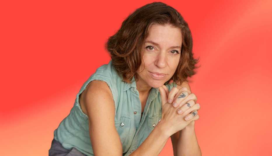 Ani DiFranco against peach-colored ombre background ani difranco against peach-colored ombre background