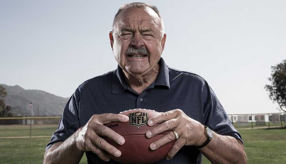 hall of fame chicago bears linebacker holding a football while posing for a portrait in california