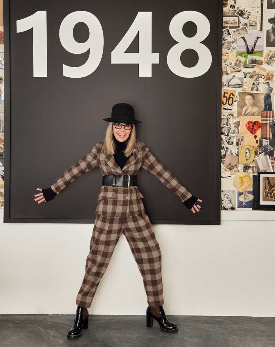 Keaton in her home office under a large picture that says 1948 Keaton in her home office under a large picture that says 1948