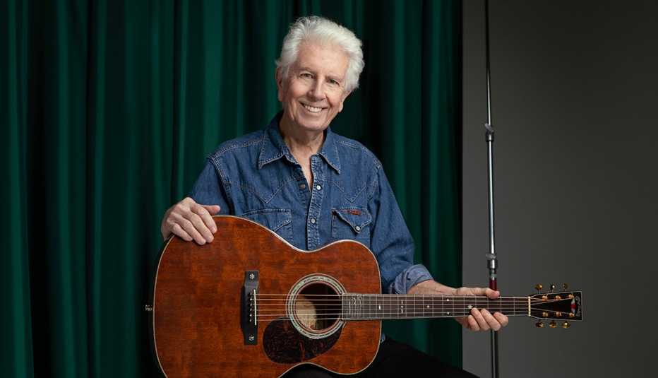 Musician Graham Nash poses with his guitar Musician Graham Nash poses with his guitar