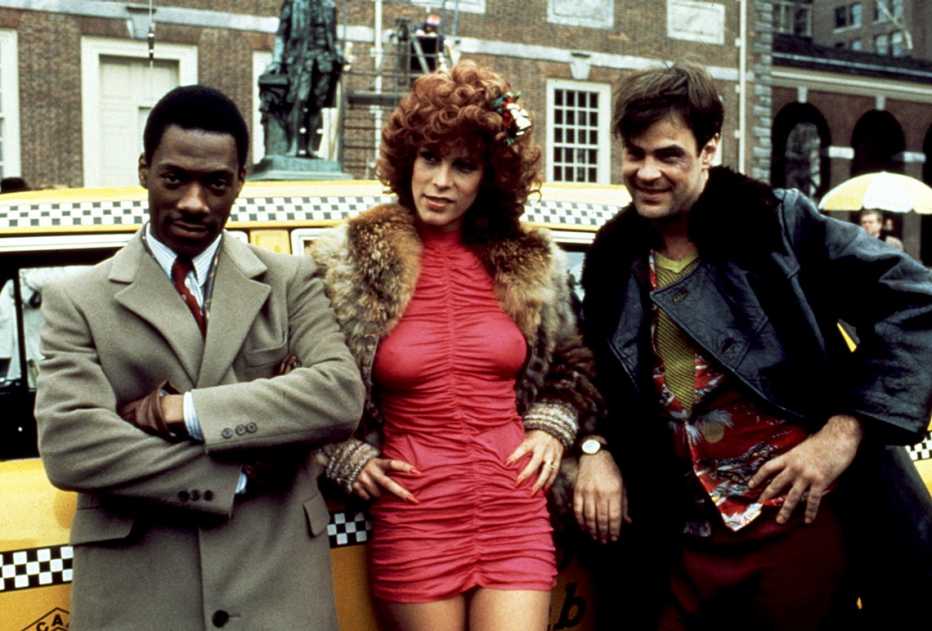 eddie murphy and jamie lee curtis and dan aykroyd in the movie trading places
