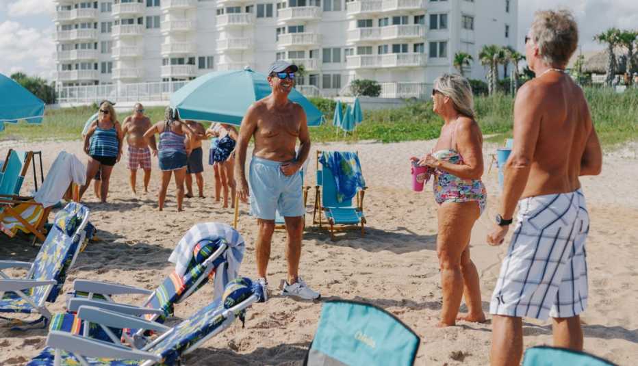 people on the beach at latitudes margaritaville retirement community