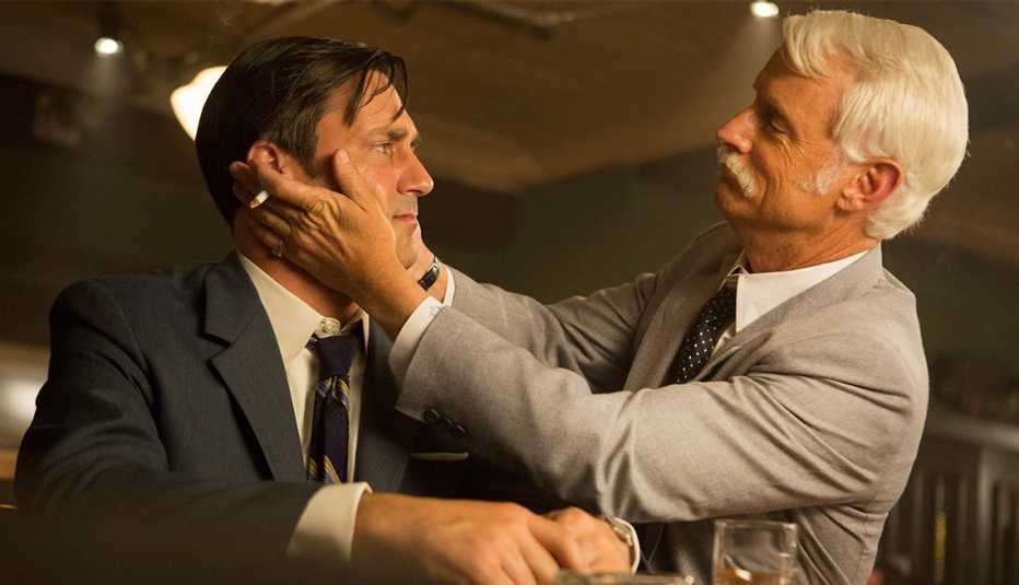 john slattery with cigarette in hand grabbing jon hamm's face in still from mad men john slattery with cigarette in hand grabbing jon hamm's face in still from mad men