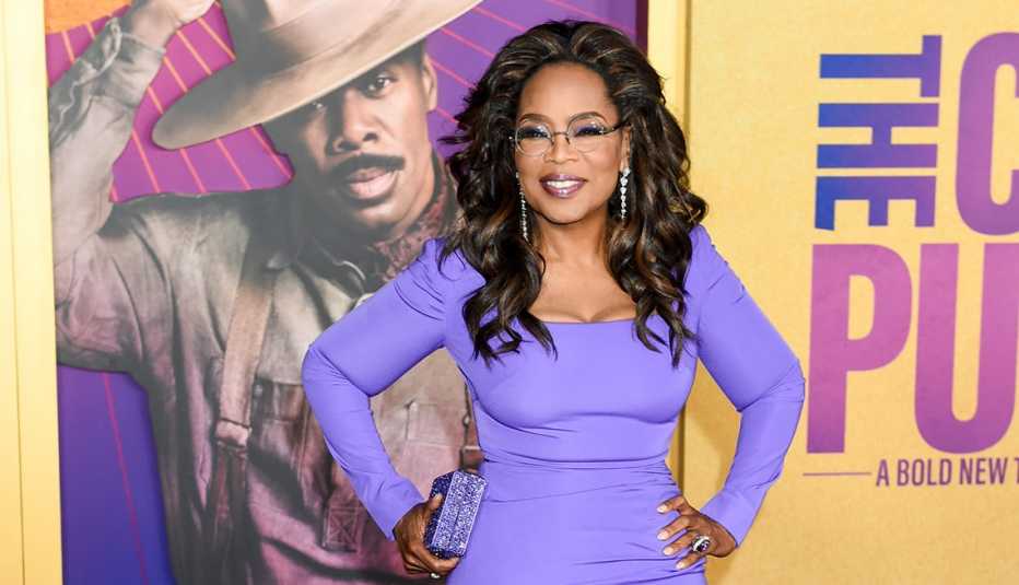 oprah winfrey at the color purple premiere  in december twenty twenty three wearing a purple dress