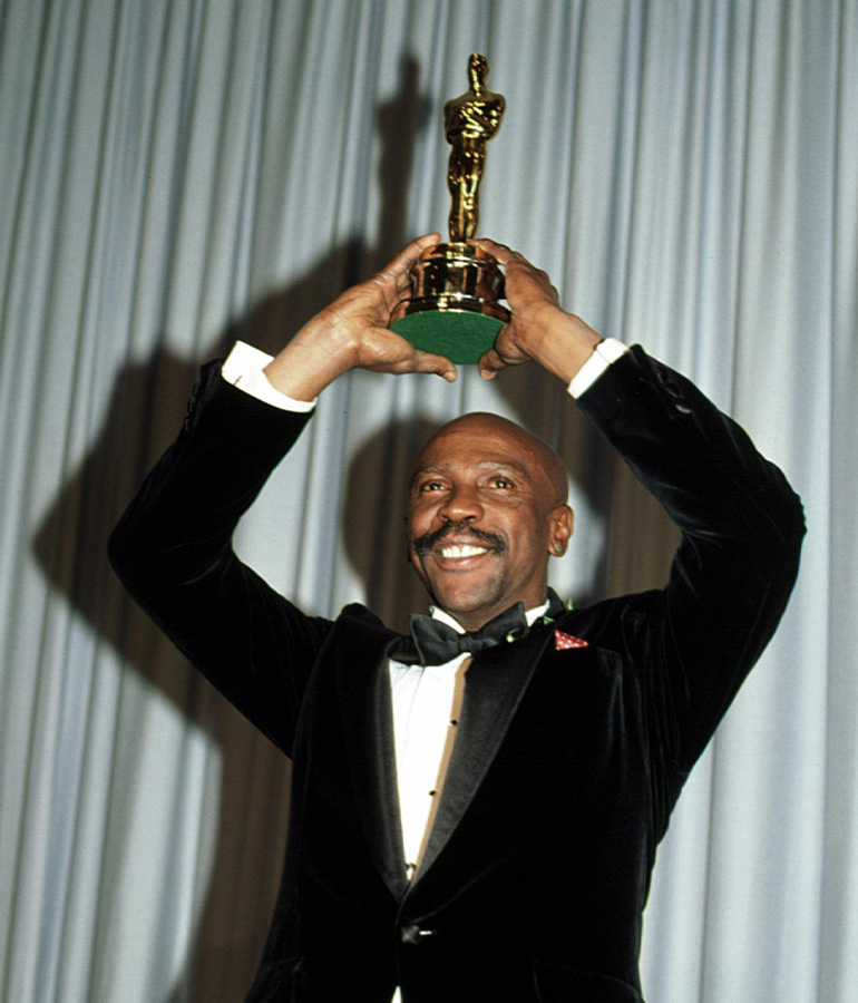 louis gossett junior holding an Oscar statuette above his head