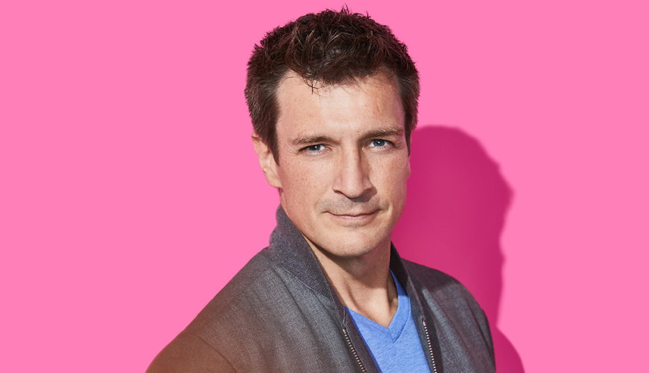 nathan fillion headshot against pink background