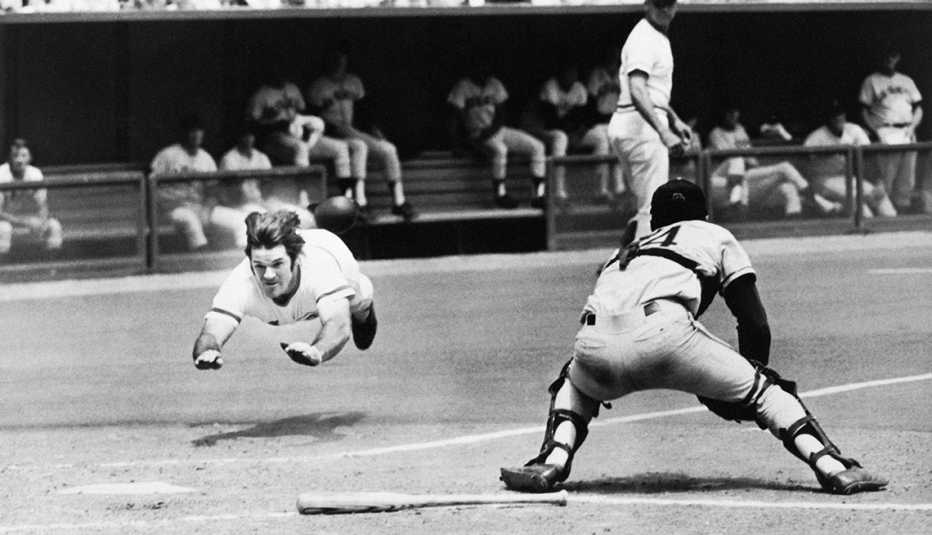 Pete Rose dives into home plate