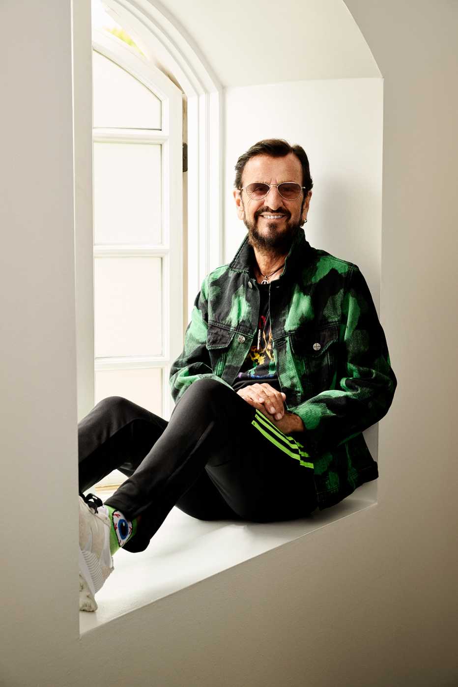 ringo starr sitting in a window