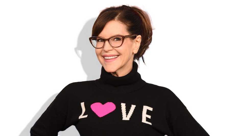 lisa loeb wearing black shirt that says love against white background