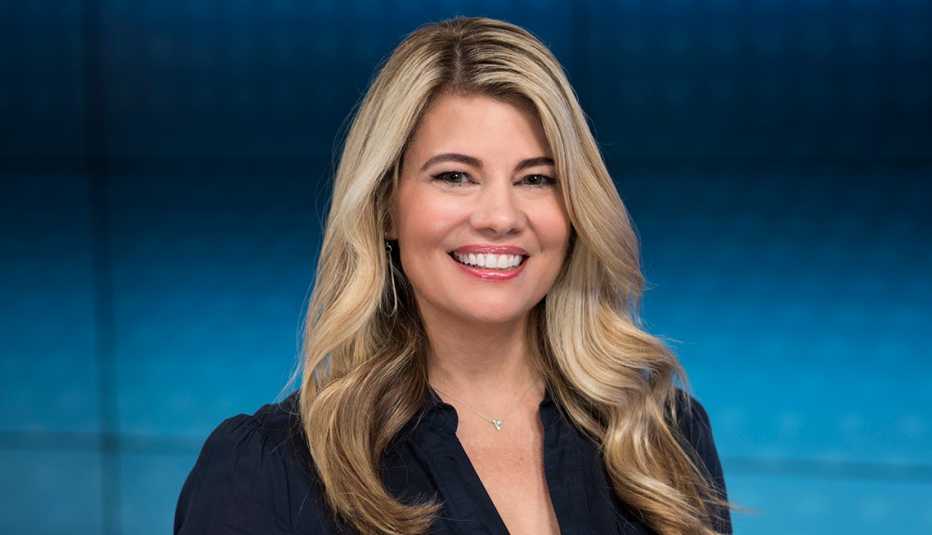 TV actress Lisa Whelchel poses in front of a blue background