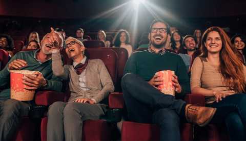 People enjoying a film in a movie theater people sitting in a movie theater enjoying a film