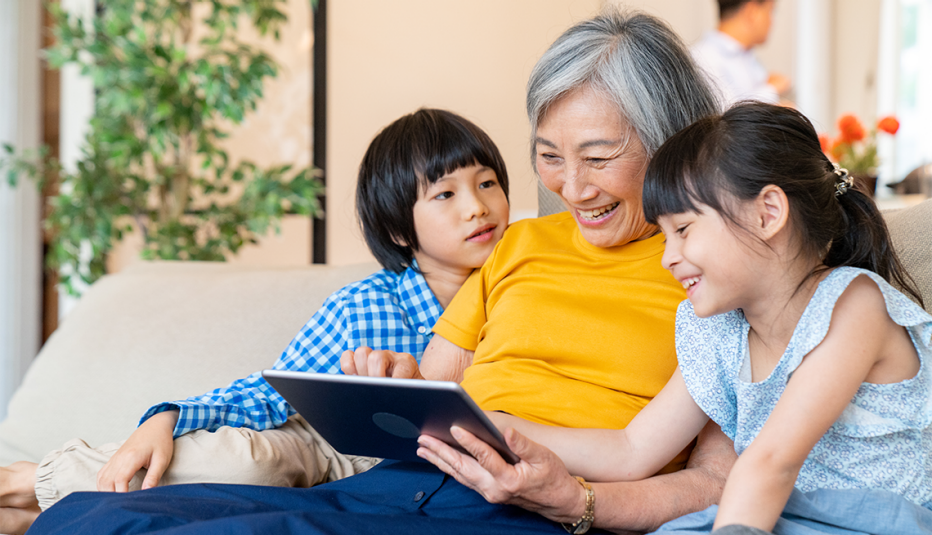 A grandmother reading to her grandchildren
