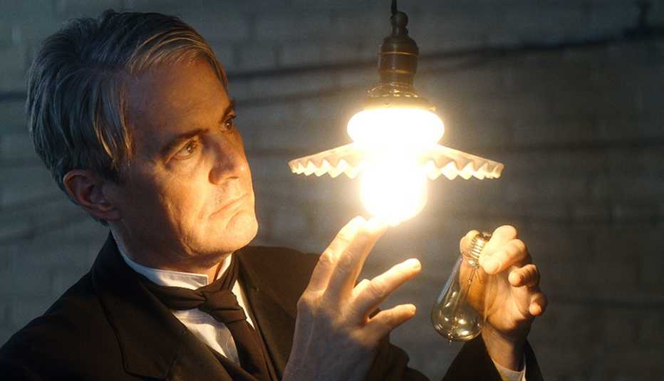 Kyle MacLachlan looks at a light bulb as he stars as Thomas Edison in the film Tesla