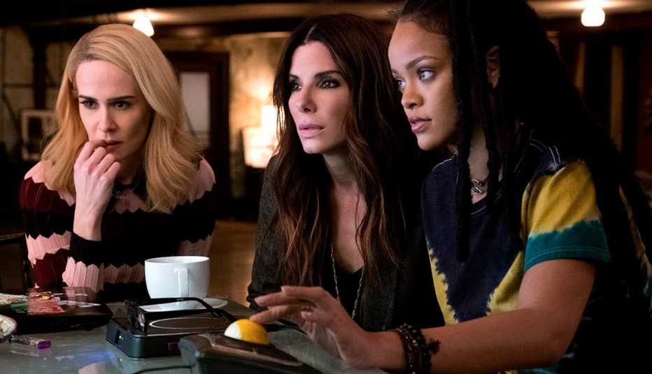 Sarah Paulson, Sandra Bullock, and Rihanna look at a screen in 'Ocean's 8'