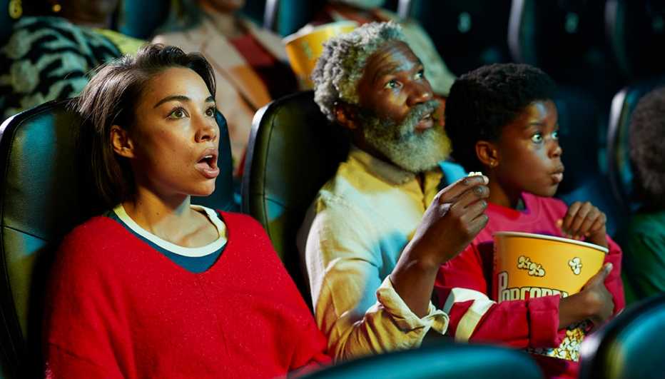 people watching a movie in a theater people watching a movie in a theater