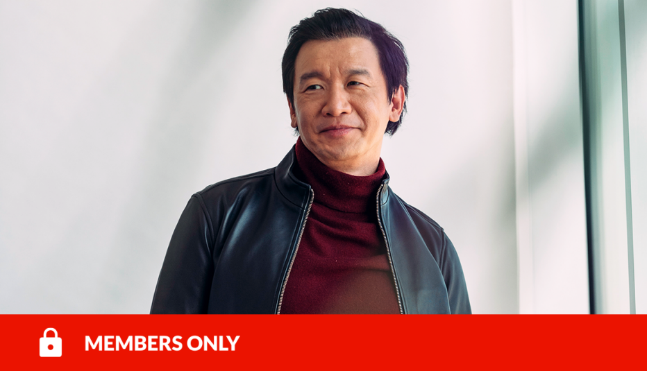 chin han standing in front of white wall; red members only banner with lock icon on bottom