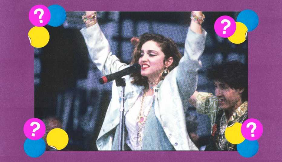 Madonna singing into microphone with arms raised in air; surrounded by yellow, blue and purple circles with question marks in them on purple background