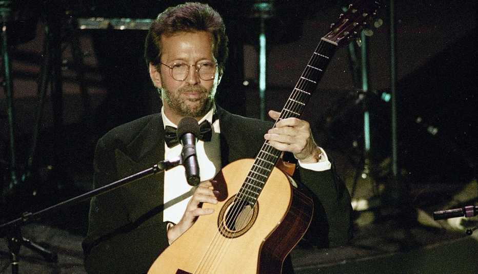 Eric Clapton holds his guitar onstage during his performance of Tears in Heaven at the 35th annual Grammy Awards Eric Clapton holds his guitar onstage during his performance of Tears in Heaven at the 35th annual Grammy Awards