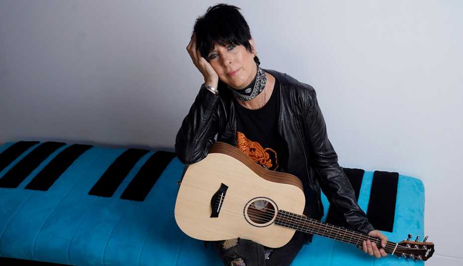 Songwriter Diane Warren holding a guitar