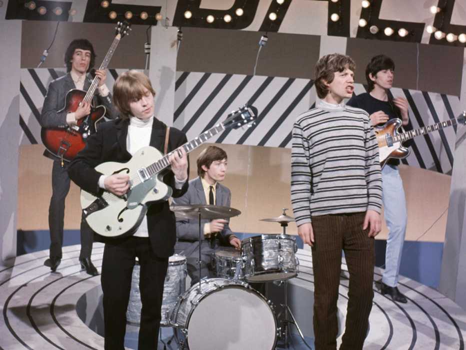 The Rolling Stones, featuring Mick Jagger, Keith Richards, Brian Jones, Bill Wyman and Charlie Watts, performing on a mid-1960's TV show. the rolling stones performing on a t v show in the mid nineteen sixties