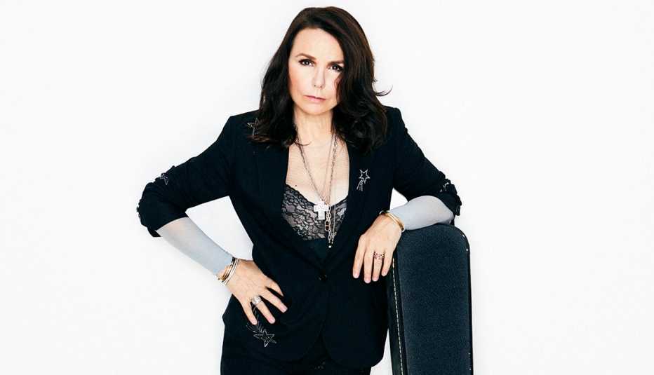Patty Smyth standing next to a guitar case