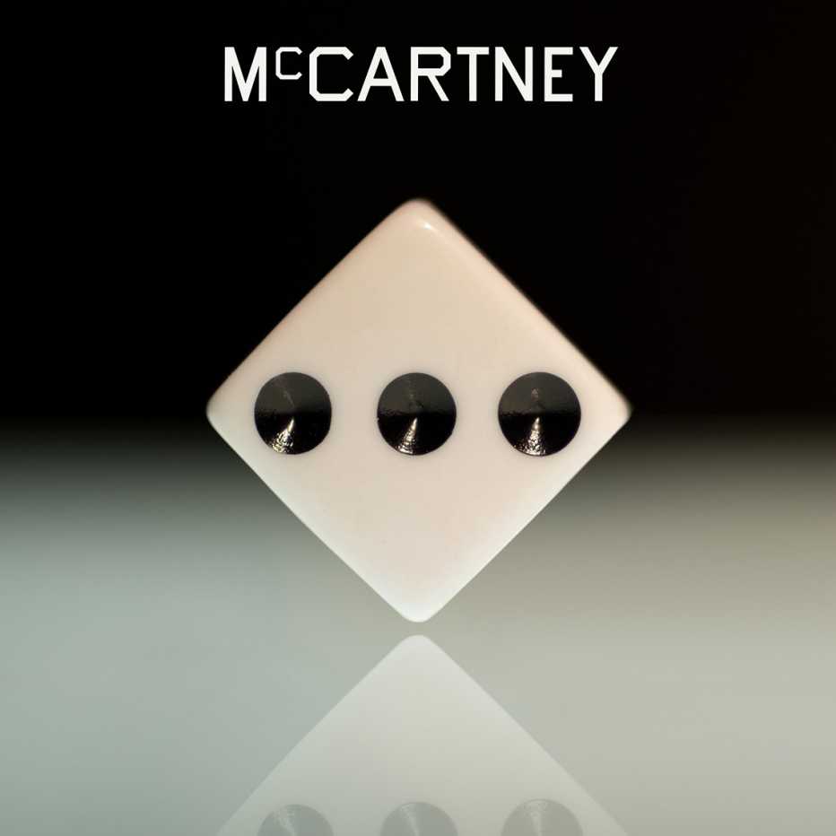 The album cover art for McCartney III, a rendering of a die balanced on one point with three dots facing the viewer The album cover art for McCartney III, a rendering of a die balanced on one point with three dots facing the viewer