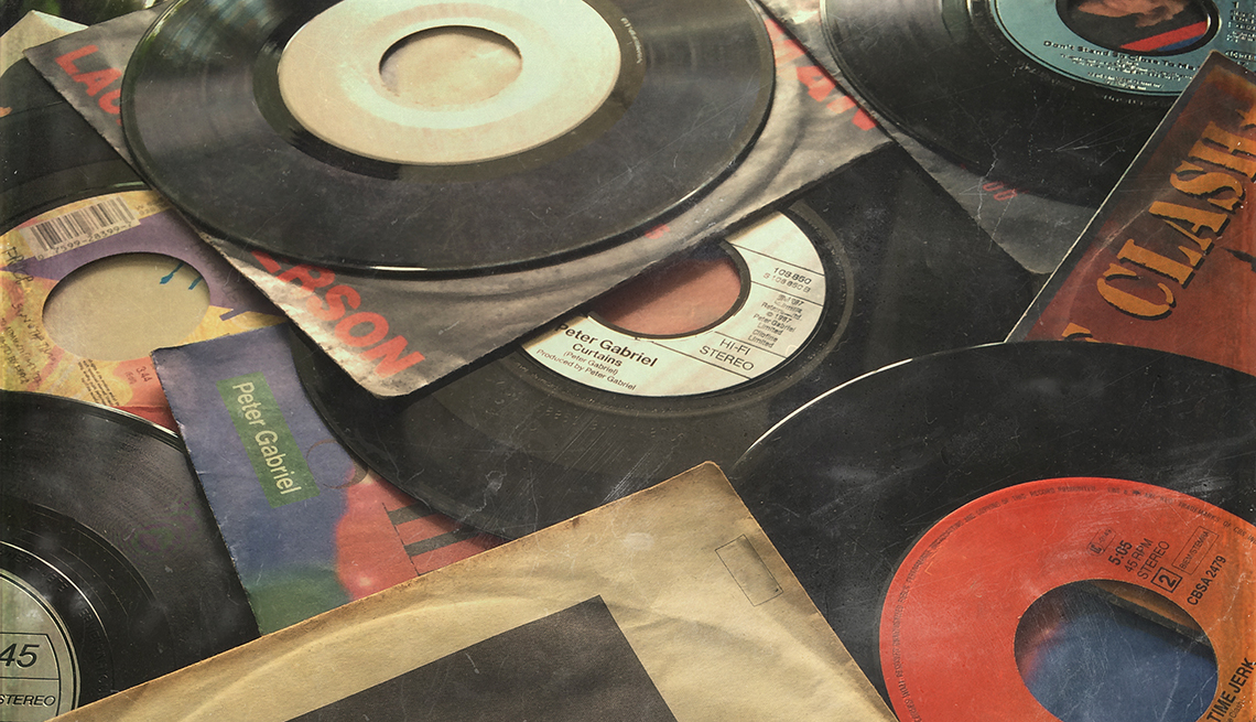 old records out of sleeves laid out in a messy pile