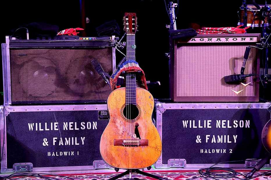 Willie Nelson's Martin guitar "Trigger" placed on a guitar stand onstage at the Luck Welcome dinner benefitting Farm Aid in Spicewood, Texas