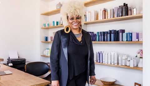 a hair stylist standing in her salon