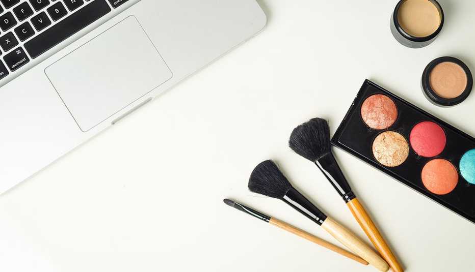 make up on table next to a laptop