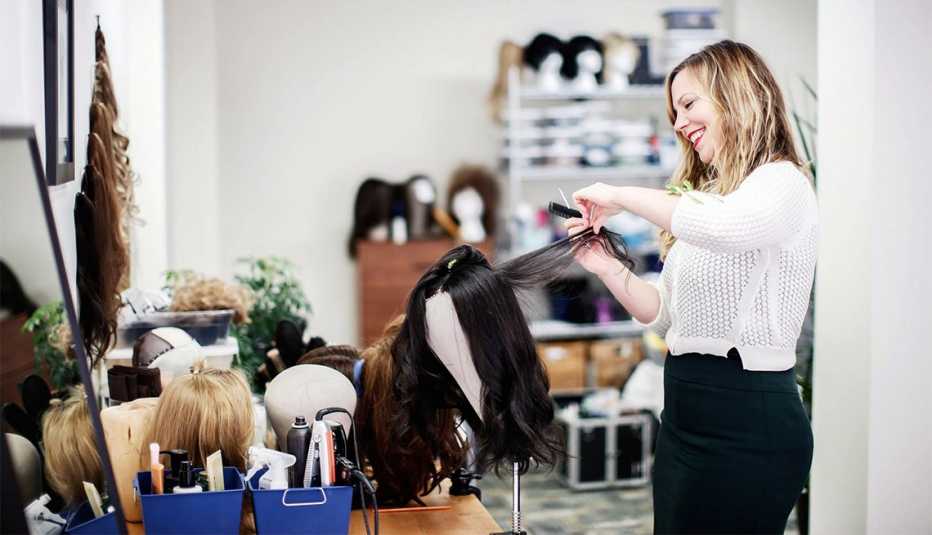 Merria Dearman works on a wig