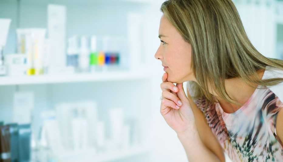 a woman looking at beuaty supplies