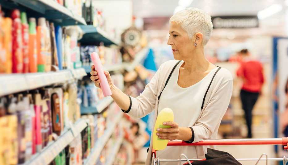 A woman looking at different beauty products in a supermarket