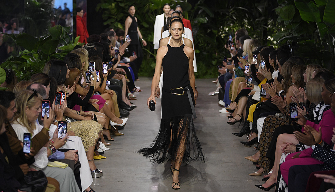 Models walking the runway in front of an audience at the Michael Kors Spring 2023 fashion show