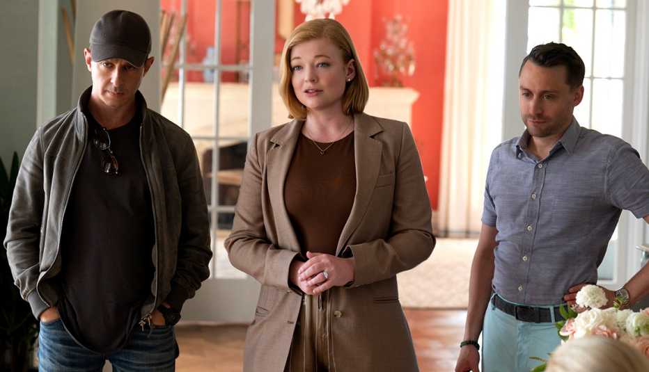 three characters standing in a room in still from succession