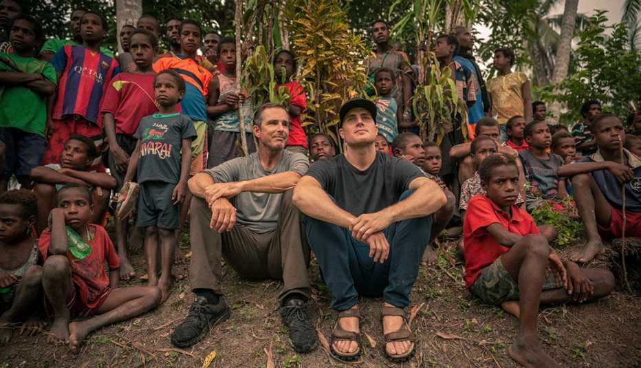 Bob and Mack Woodruff watch a traditional archery competition in Papua New Guinea with the village children