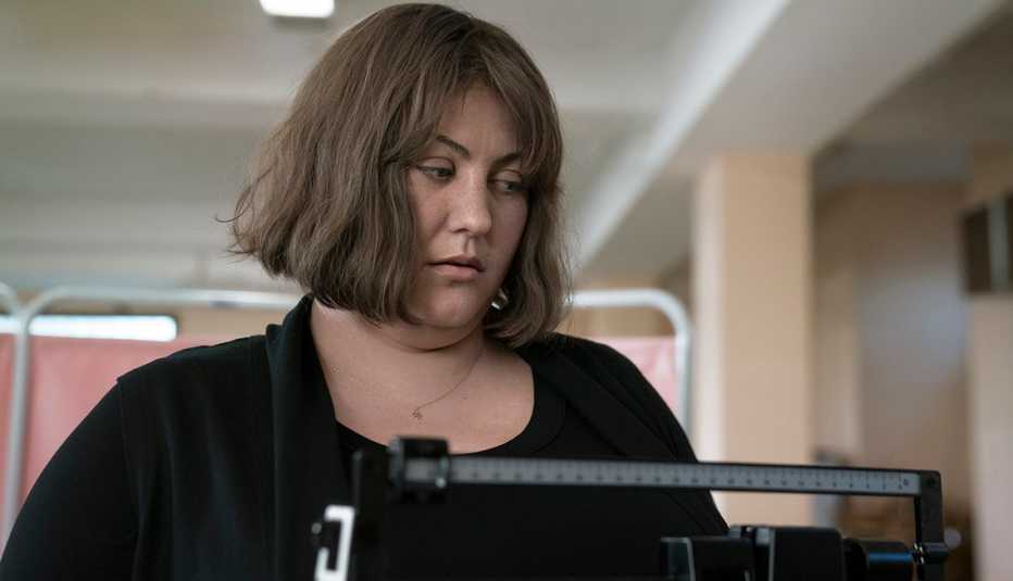 Joy Nash standing on a scale.