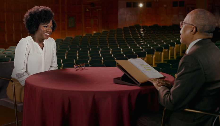 Viola Davis and Henry Louis Gates Jr. sitting across from each other at a table in Finding Your Roots Viola Davis and Henry Louis Gates Jr. sitting across from each other at a table in Finding Your Roots